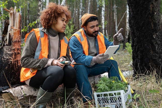 Scientists in protective gear collecting samples from a remediated site, demonstrating safe handling procedures and environmental monitoring in a field setting.