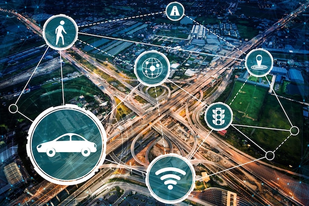 A detailed diagram showing sensors at a smart intersection communicating with a self-driving car on a multi-lane highway, highlighting sensor data flow and network connectivity.