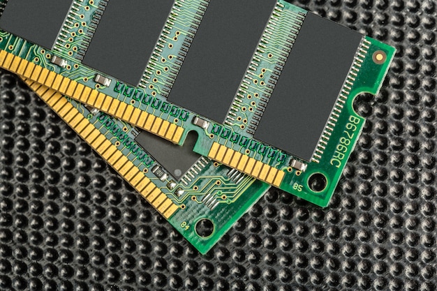 A close-up of DDR5 RAM modules installed on a motherboard, highlighting the heat spreaders and identifying the RAM speed and timings printed on the label, set against a backdrop of a modern PC build.