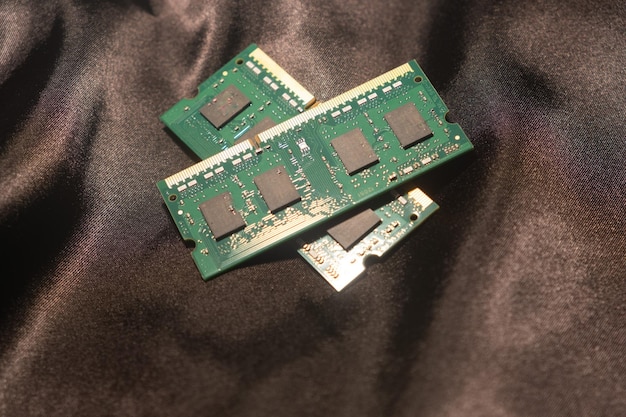 A close-up shot of several VRAM chips on a graphics card, with markings indicating their capacity and speed (e.g., 