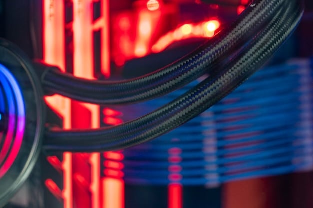 A close-up of a custom liquid cooling loop inside a gaming PC, highlighting the transparent tubing, water blocks on the CPU and GPU, and the reservoir filled with colored coolant, showcasing the aesthetic appeal and complexity of the system.