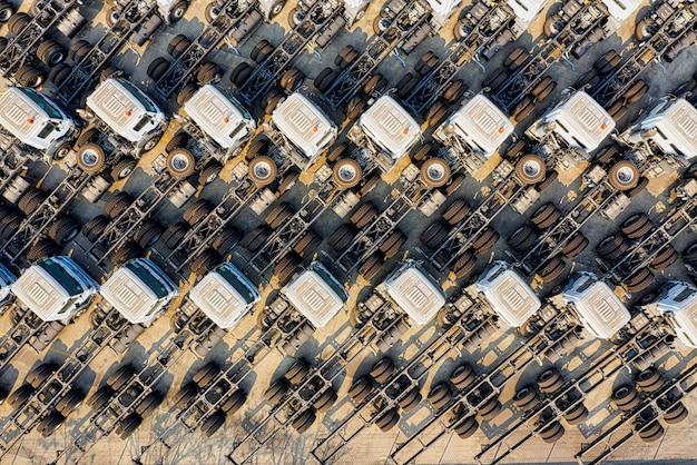 A fleet of autonomous construction vehicles, including excavators and dozers, operating efficiently on a large commercial building site under clear skies, demonstrating automated heavy machinery in action.