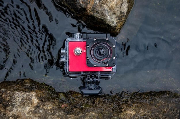 A close-up shot of a durable action camera submerged partially in clear water, showcasing its waterproof design and the vibrant 4K display on its rear screen, with adventure gear faintly visible in the background.