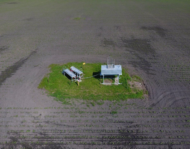 A drone meticulously inspecting a vast field of solar panels, highlighting renewable energy infrastructure maintenance through robotics.