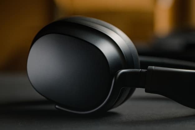 A close-up of a sleek, black noise-canceling headphone lying on a charging pad, highlighting its modern design and wireless charging capabilities.